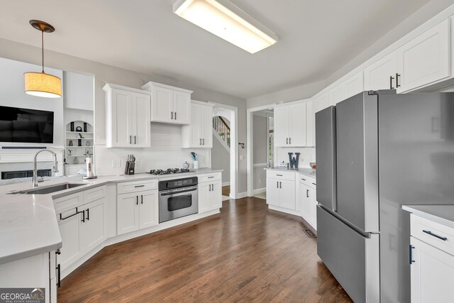 1584 Heartland Path, Hoschton, GA 30548 - kitchen with stainless steel appliances, decorative backsplash, white cabinets, light countertops, and dark wood-type flooring
