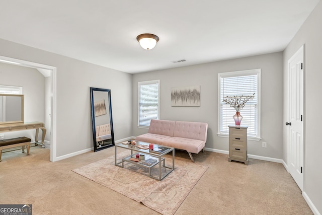 living area featuring carpet and baseboards