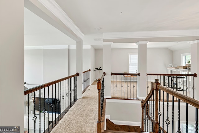 corridor with an upstairs landing and ornamental molding
