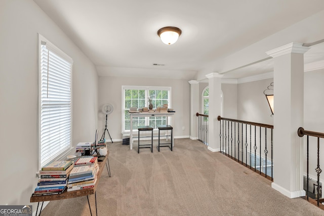 sitting room with decorative columns, carpet, and baseboards