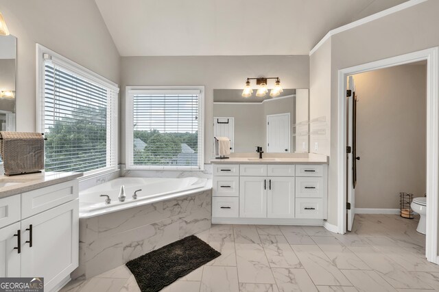1584 Heartland Path, Hoschton, GA 30548 - bathroom with marble look tiles, vanity, vaulted ceiling, and a bath