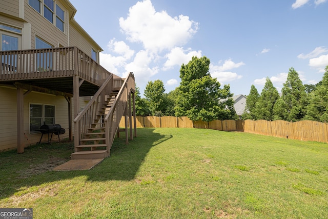 view of yard with a wooden deck and stairway