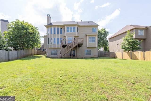 back of property featuring stairway, a wooden deck, and a chimney