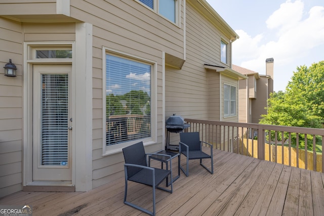 wooden terrace with a grill