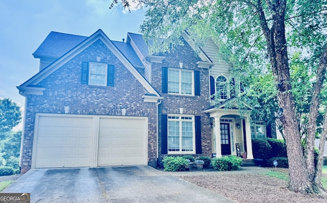 1584 Heartland Path, Hoschton, GA 30548 - traditional home featuring driveway, a garage, and brick siding