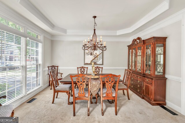 1584 Heartland Path, Hoschton, GA 30548 - dining space with a chandelier, a tray ceiling, ornamental molding, and light colored carpet