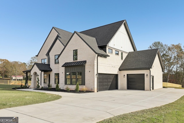modern inspired farmhouse featuring a front lawn, fence, brick siding, board and batten siding, and driveway