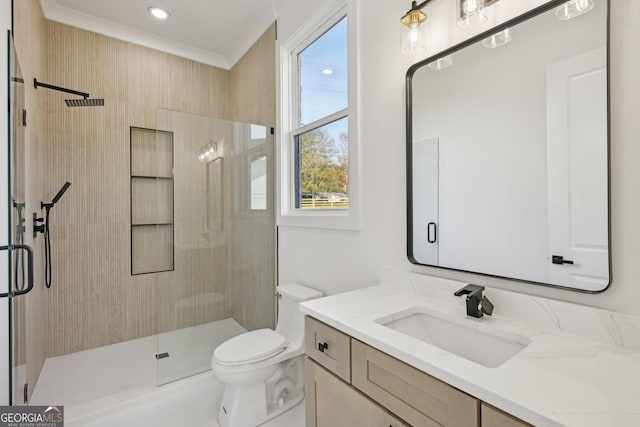 full bathroom featuring vanity, toilet, ornamental molding, and a stall shower