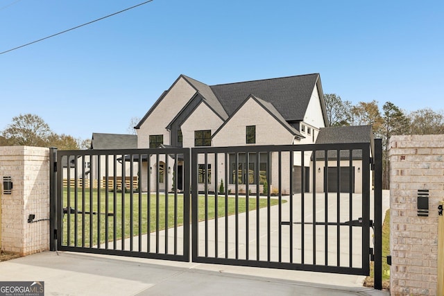 view of gate featuring a yard and fence private yard