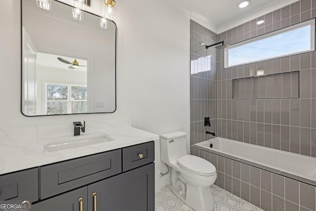 bathroom featuring toilet, plenty of natural light, shower / bathing tub combination, and vanity