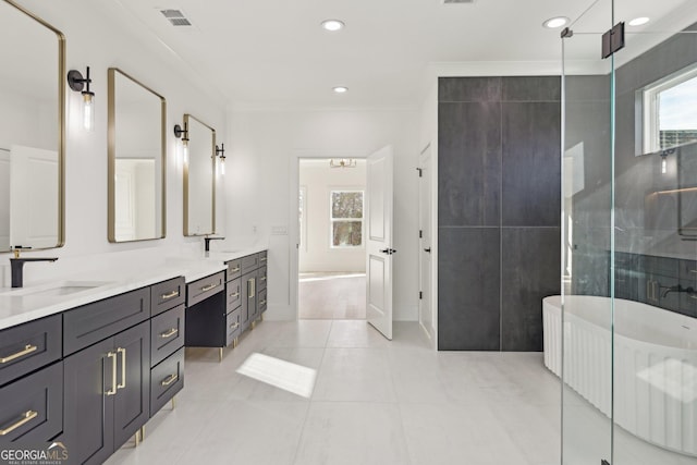 full bath with visible vents, double vanity, ornamental molding, a freestanding bath, and a sink