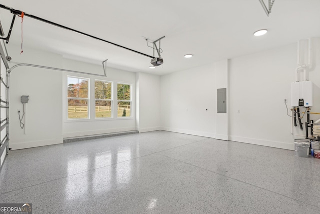 garage with baseboards, a garage door opener, recessed lighting, and electric panel