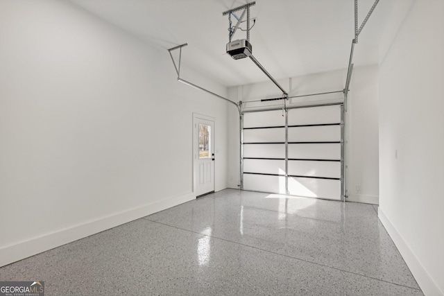 garage with baseboards and a garage door opener
