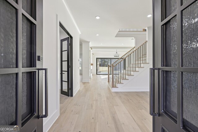 foyer entrance featuring baseboards, recessed lighting, stairway, and light wood-type flooring