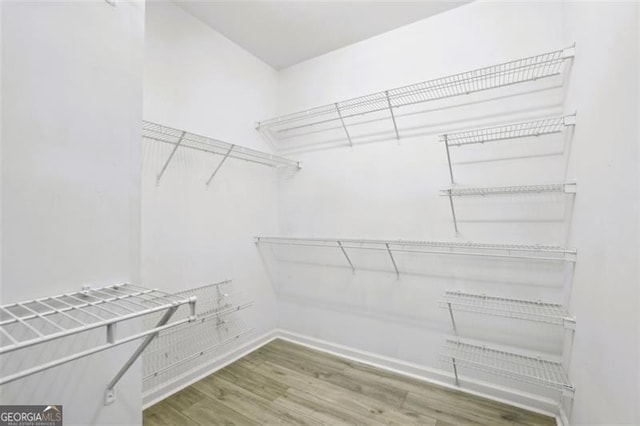 7712 Soaring Eagle Dr, Flowery Branch, GA 30542 - spacious closet with wood finished floors