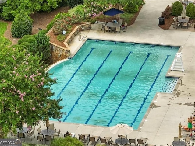 7712 Soaring Eagle Dr, Flowery Branch, GA 30542 - community pool with outdoor dining area and a patio