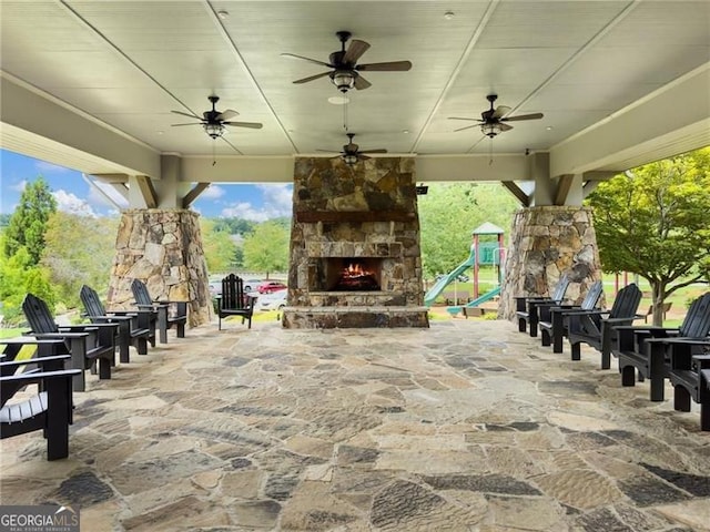 7712 Soaring Eagle Dr, Flowery Branch, GA 30542 - view of patio featuring an outdoor stone fireplace and a ceiling fan