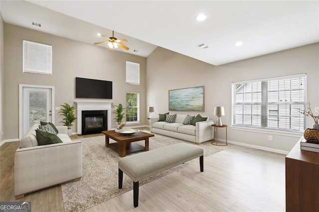 7712 Soaring Eagle Dr, Flowery Branch, GA 30542 - living room featuring light wood-type flooring, plenty of natural light, a fireplace with flush hearth, ceiling fan, and recessed lighting