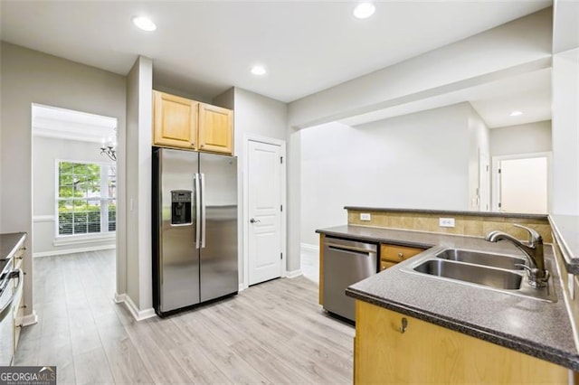 7712 Soaring Eagle Dr, Flowery Branch, GA 30542 - kitchen with stainless steel appliances, light brown cabinets, dark countertops, light wood-style floors, and a chandelier