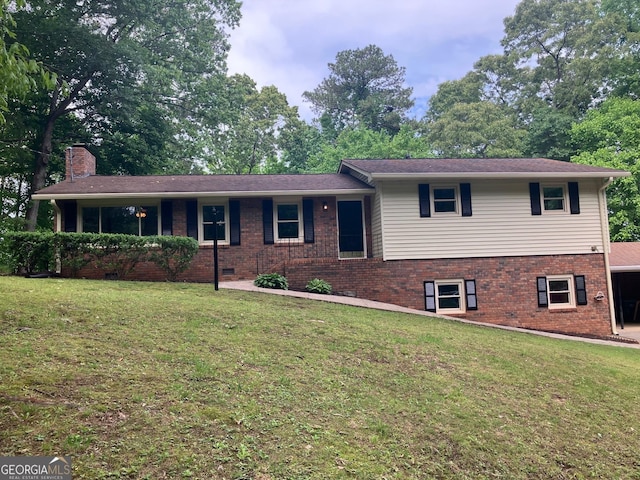 view of front of house with brick siding, a front lawn, a chimney, and a porch