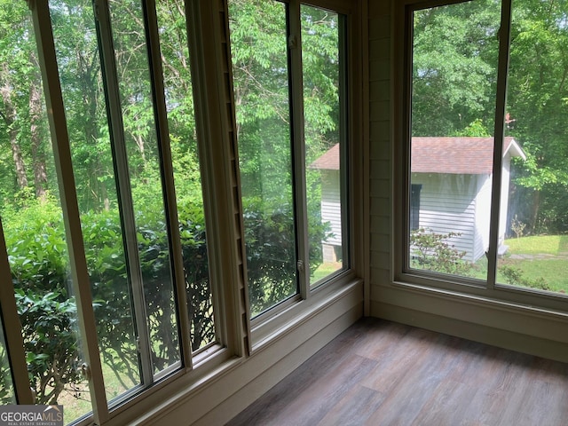 unfurnished sunroom featuring wood finished floors