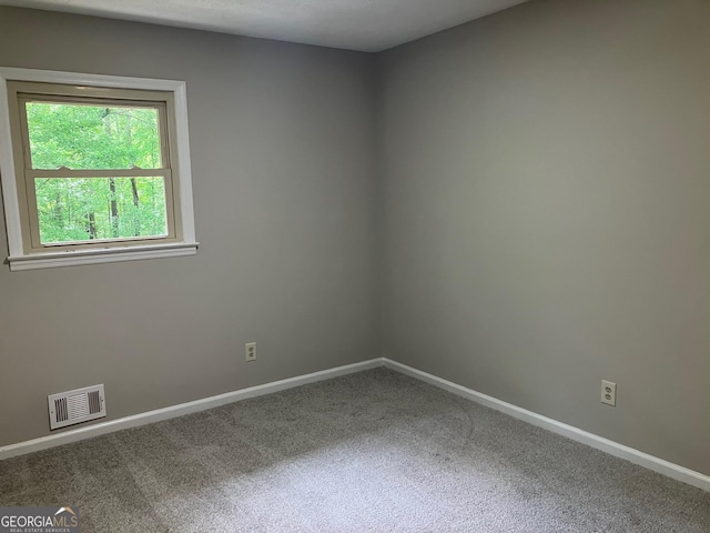 carpeted empty room with baseboards and visible vents