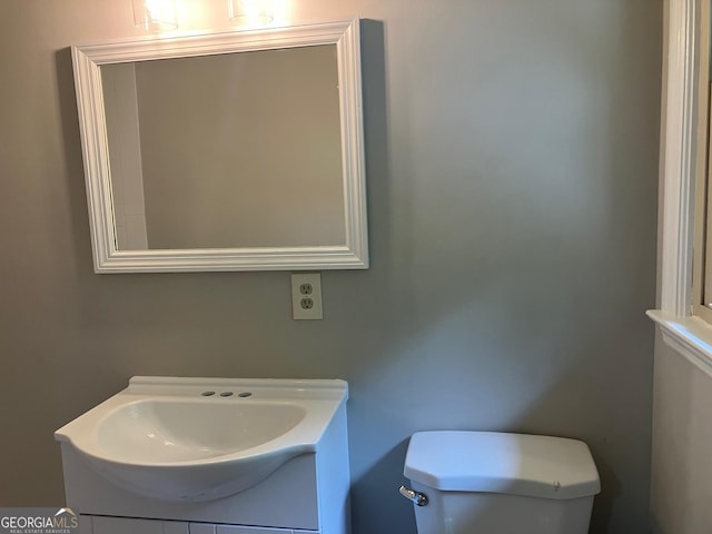 bathroom featuring toilet and vanity