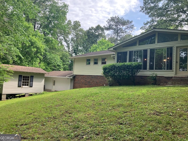 rear view of house featuring a yard