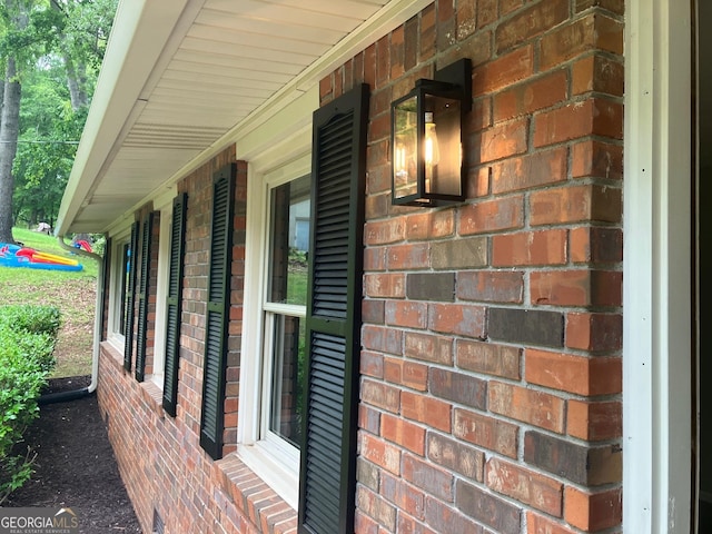 view of side of property featuring a porch and brick siding