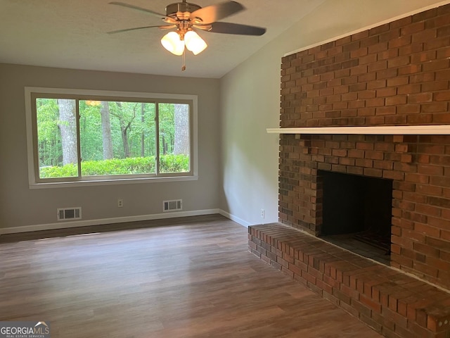 unfurnished living room with visible vents, baseboards, ceiling fan, and wood finished floors