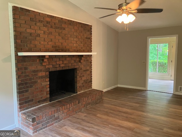 unfurnished living room with baseboards, ceiling fan, wood finished floors, and lofted ceiling