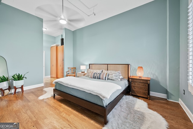 3820 Roswell Rd NE Unit 705, Atlanta, GA 30342 - bedroom featuring wood finished floors, attic access, baseboards, a towering ceiling, and a ceiling fan