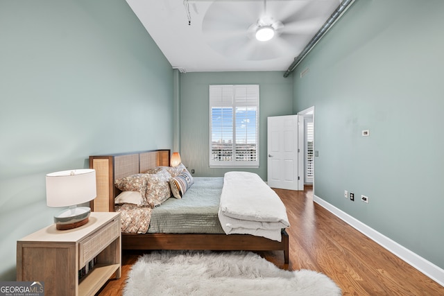 3820 Roswell Rd NE Unit 705, Atlanta, GA 30342 - bedroom with baseboards, wood finished floors, and a ceiling fan