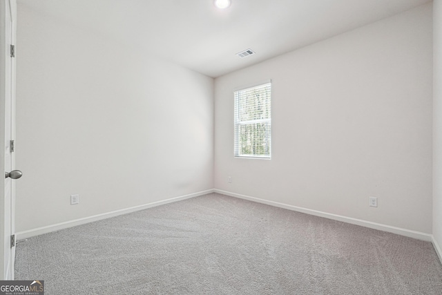 carpeted spare room featuring baseboards, recessed lighting, and visible vents