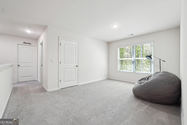 living area featuring recessed lighting, baseboards, visible vents, and carpet