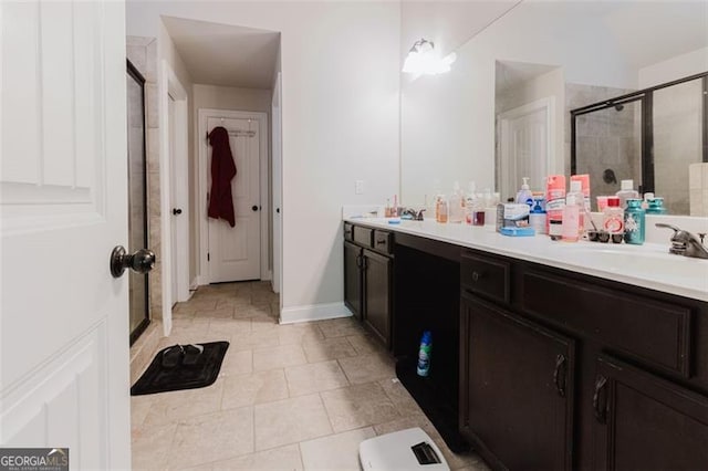 full bathroom with double vanity, tile patterned floors, and a stall shower