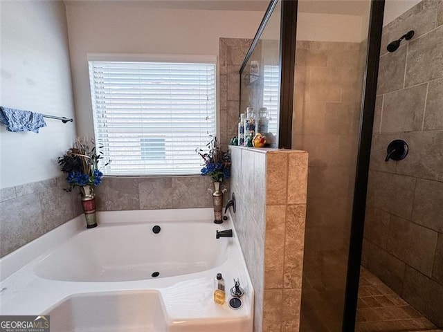 full bath featuring a garden tub and a stall shower