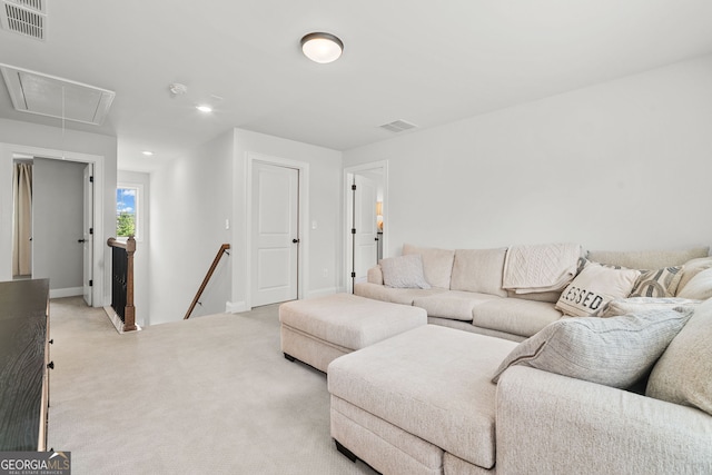 living room with light colored carpet, visible vents, recessed lighting, and attic access