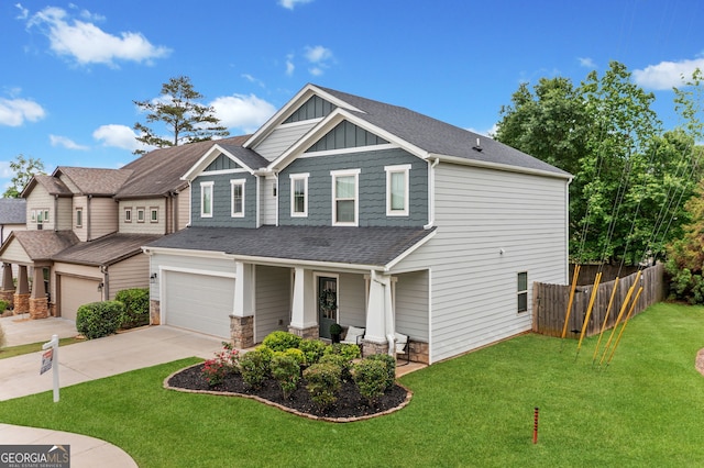 craftsman house featuring fence, covered porch, roof with shingles, board and batten siding, and driveway