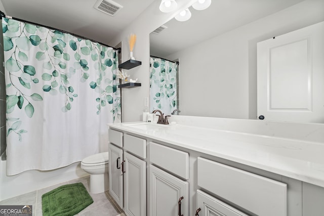 bathroom featuring toilet, tile patterned floors, visible vents, and vanity