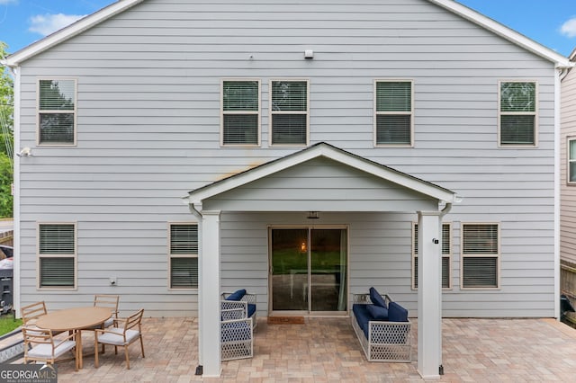 back of property with a patio