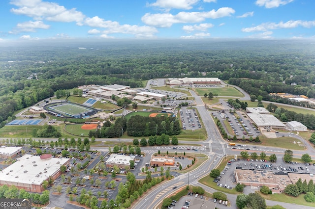 bird's eye view with a wooded view