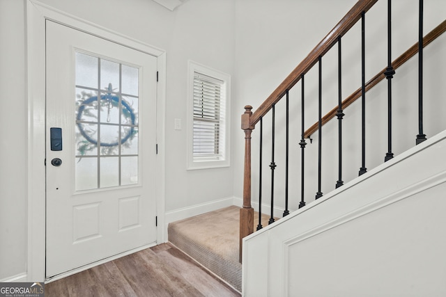 entryway with plenty of natural light, baseboards, and stairway