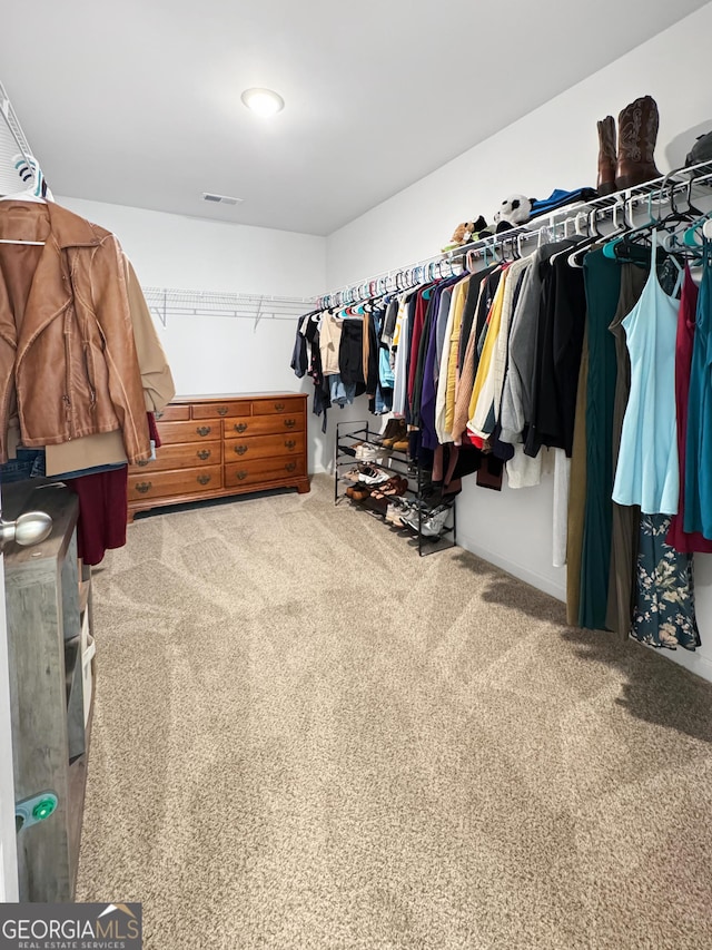 walk in closet with carpet floors and visible vents