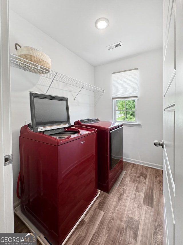 314 Vine Ct, Griffin, GA 30223 - washroom featuring washing machine and dryer, wood finished floors, and baseboards