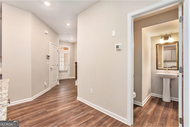 hall with baseboards, recessed lighting, and wood finished floors