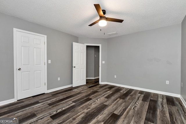 150 Buckeye Trails Dr, Commerce, GA 30530 - unfurnished bedroom with visible vents, dark wood-style flooring, baseboards, a textured ceiling, and a ceiling fan