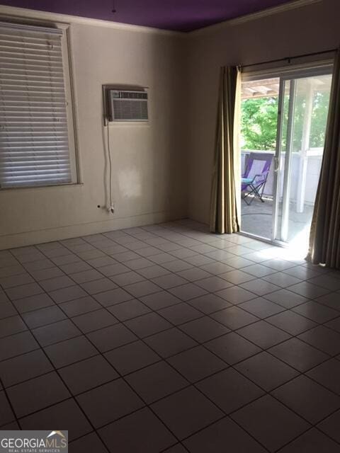 tiled spare room with crown molding and a wall unit AC