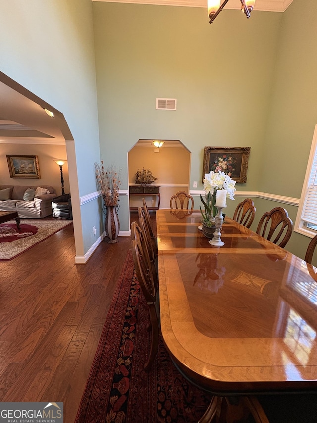 108 Hope Ln, Cedartown, GA 30125 - dining room featuring wood finished floors, a towering ceiling, visible vents, arched walkways, and baseboards