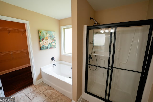 108 Hope Ln, Cedartown, GA 30125 - bathroom featuring baseboards, a shower stall, tile patterned flooring, a garden tub, and a spacious closet